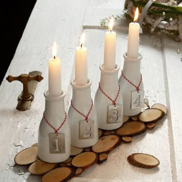 An Advent Candle Holder from Milk Bottles with numbered Zinc Tags