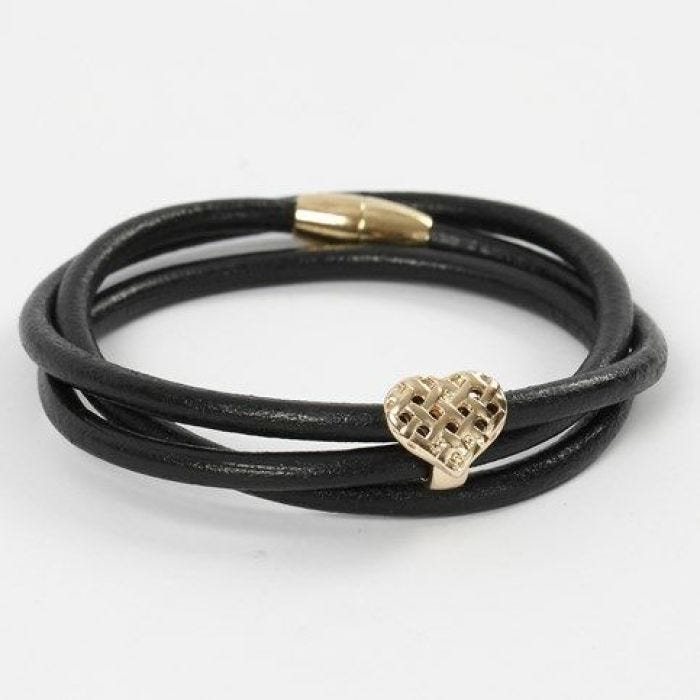 Un bracelet fait d'un cordon de cuir épais avec un coeur et un fermoir magnétique doré