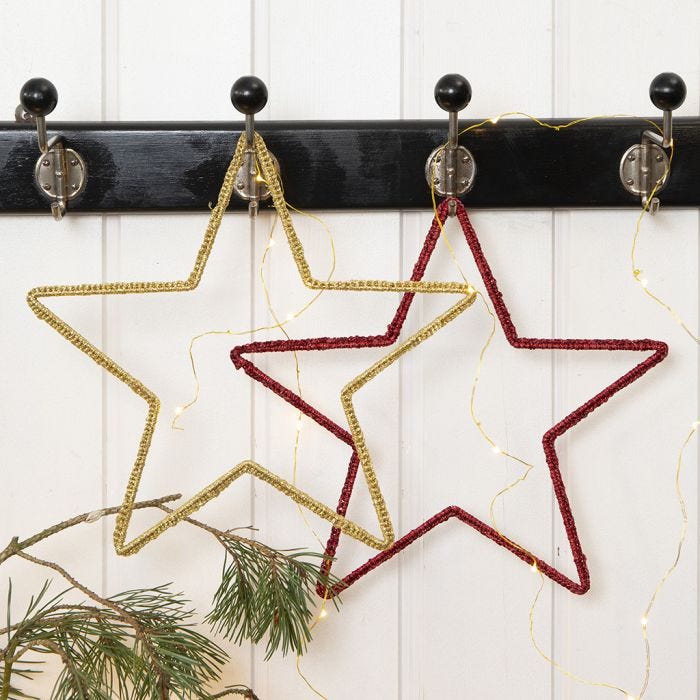 A crocheted Christmas Star on a Metal Star Frame