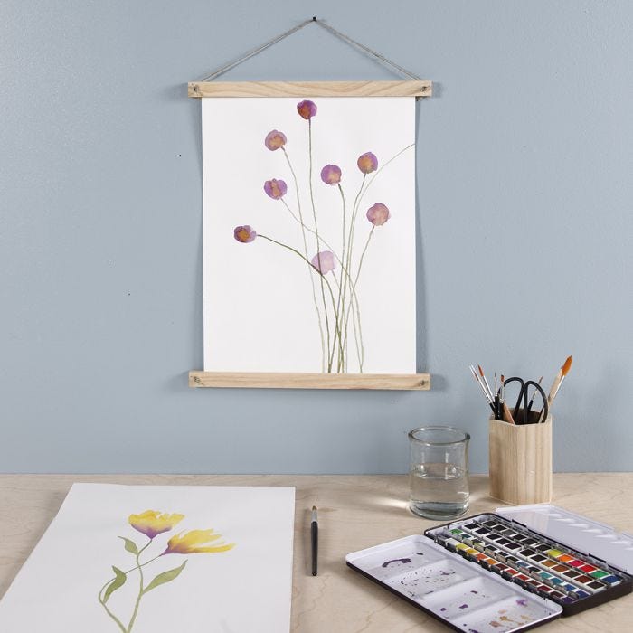 Paarse bloem geverfd met aquarelverf en opgehangen met poster hangers