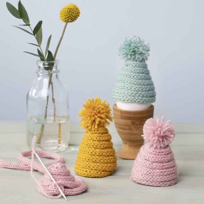 A knitted Egg Warmer from knitted Tube with a Pom-pom