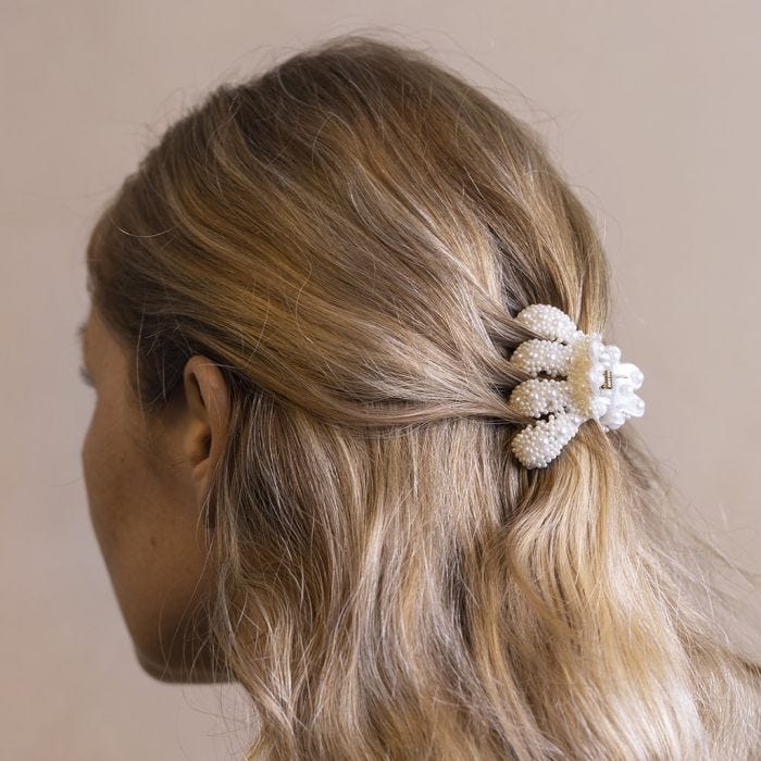 A hair claw decorated with half-pearls and mini pearlescent glass beads