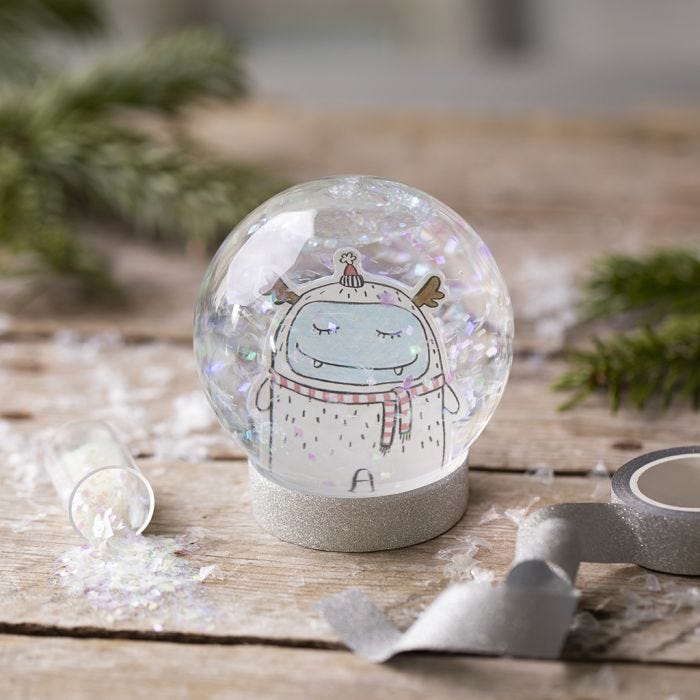 A snow globe with a drawing and glitter