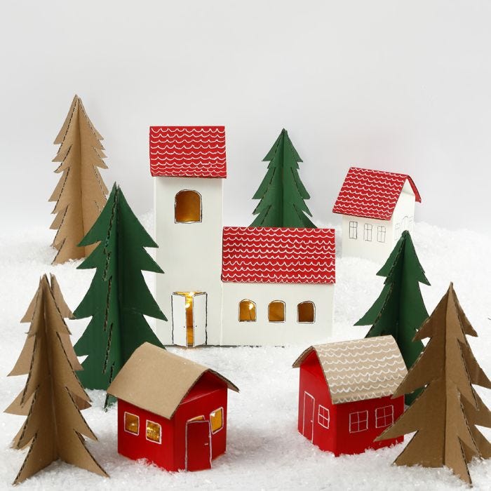 A Christmas village from milk/juice cartons and Christmas trees from recycled cardboard