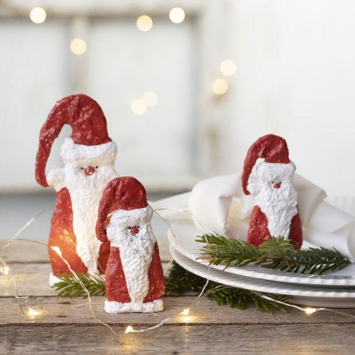 A wooden Father Christmas covered with gauze bandage