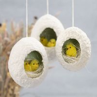 Easter eggs from papier-mâché pulp with a hole decorated with nesting chicks